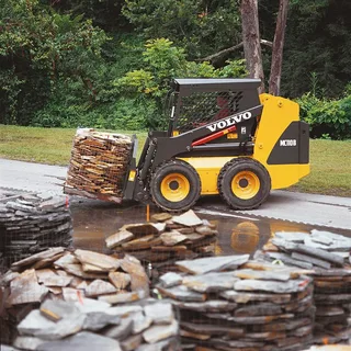 Tractor performing gravel driveway installation in Texas